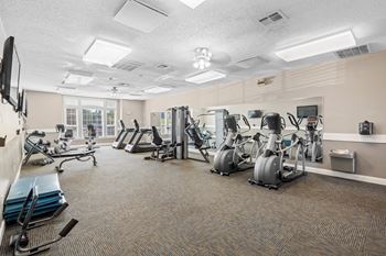 A fitness center with treadmills and other fitness equipment at Stonebriar Apartments in Overland Park, KS.